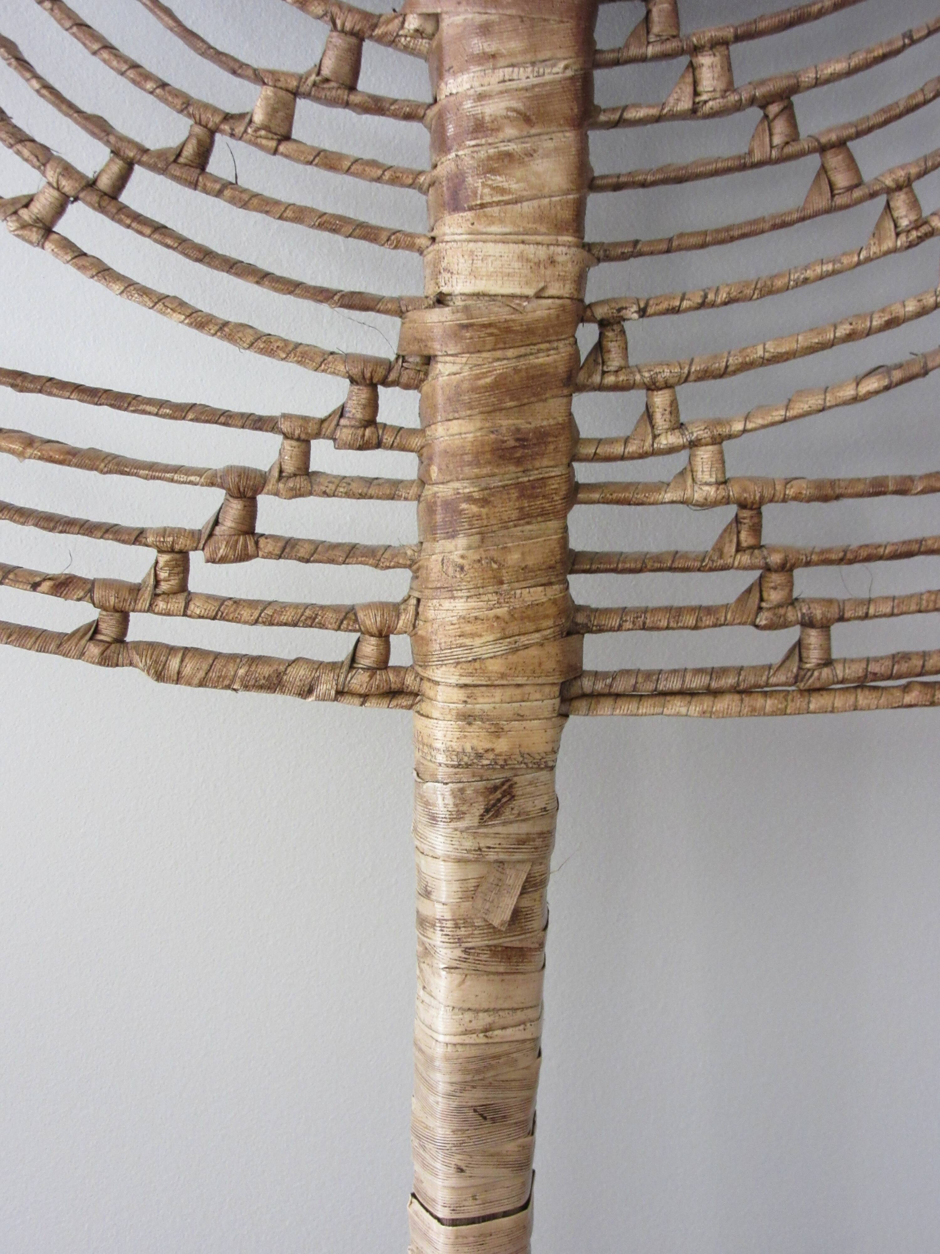 Vintage fan in palm leaves