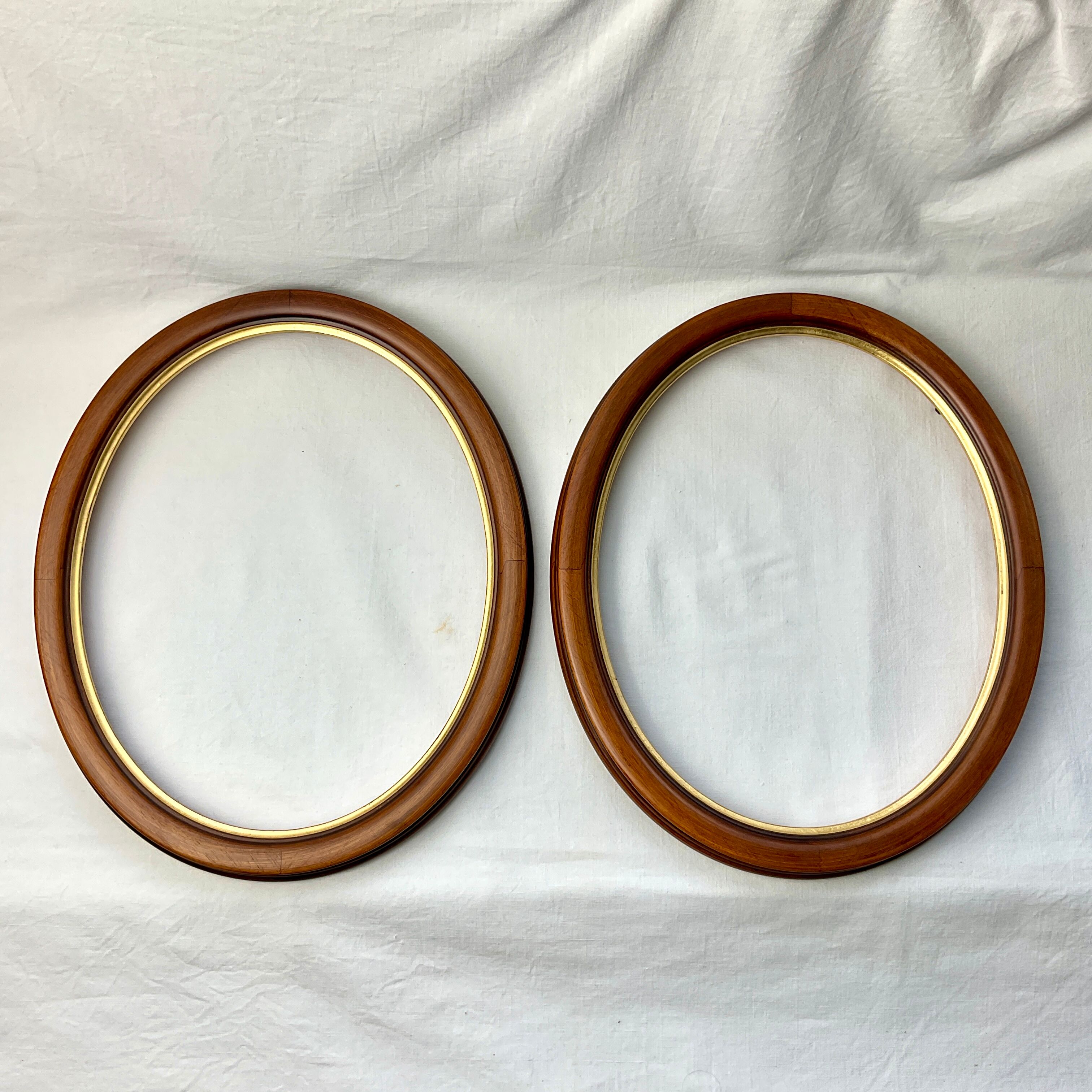 Pair of oval wooden frames with gilding