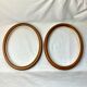 Pair of oval wooden frames with gilding