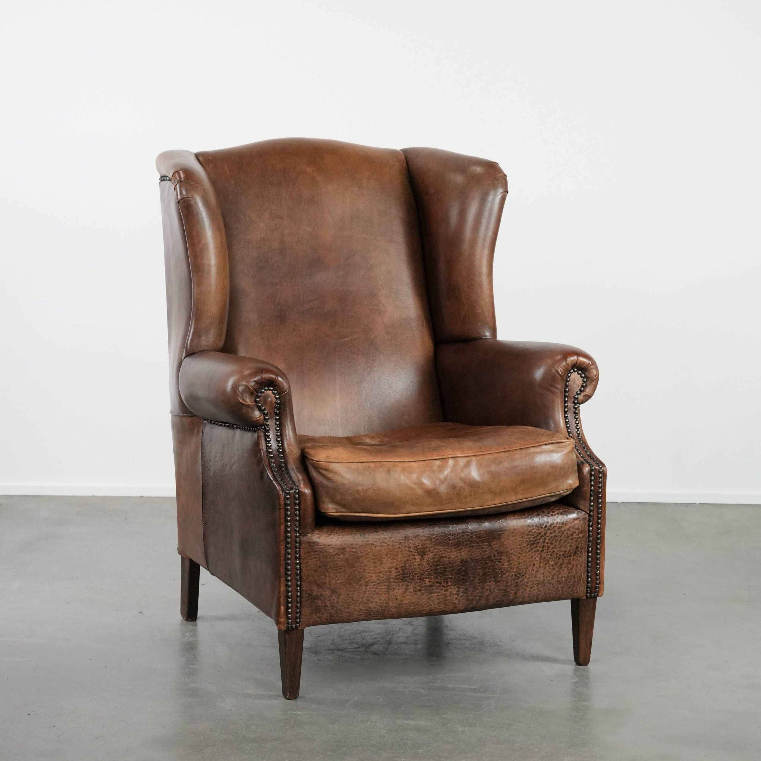 Warm, cosy and comfortable vintage sheepskin ear armchair with character