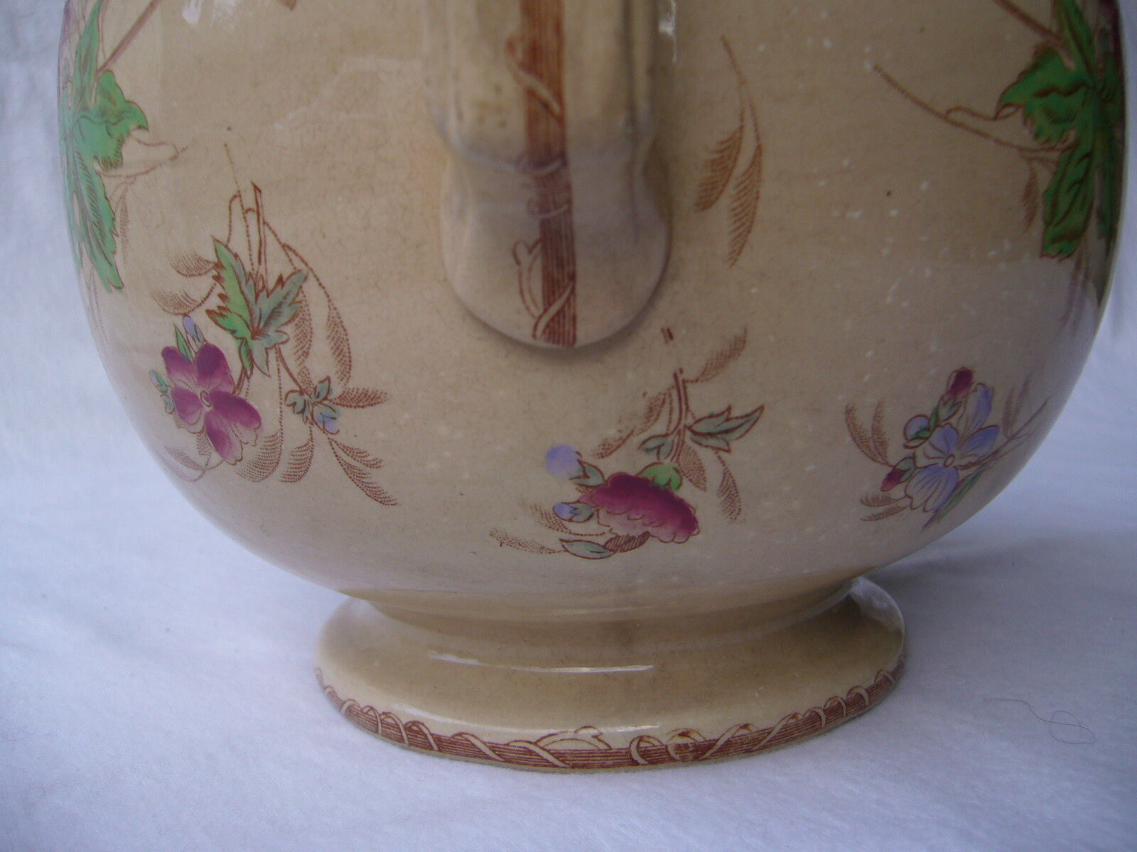 Antique pitcher decorated with flowers