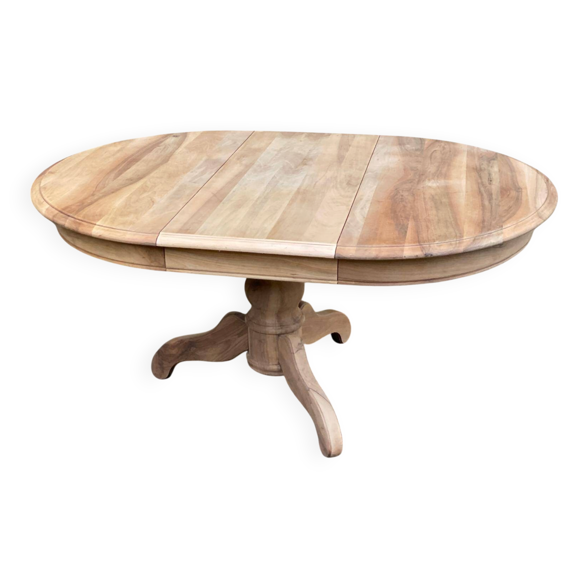 Round extendable dining table stripped in solid raw walnut with a central leg.