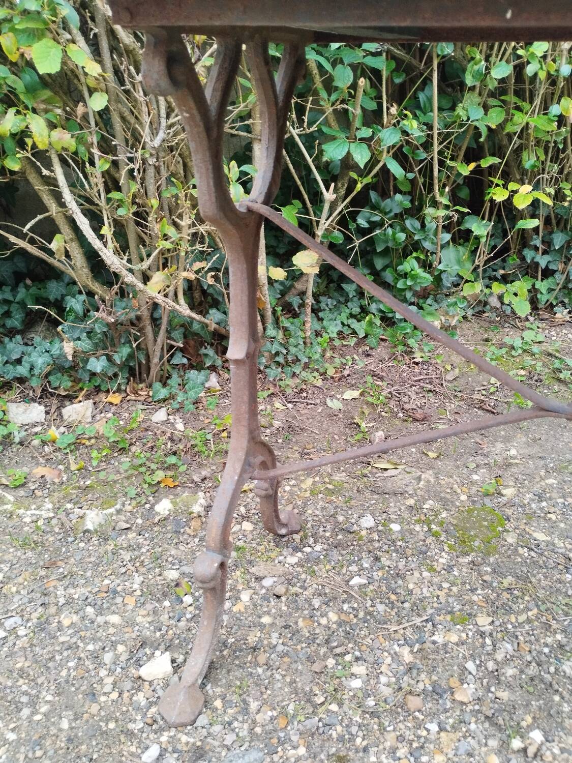 Antique bistro table with iron legs and wooden top