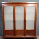 Large pine bookcase with three doors, fitted with frosted glass.
