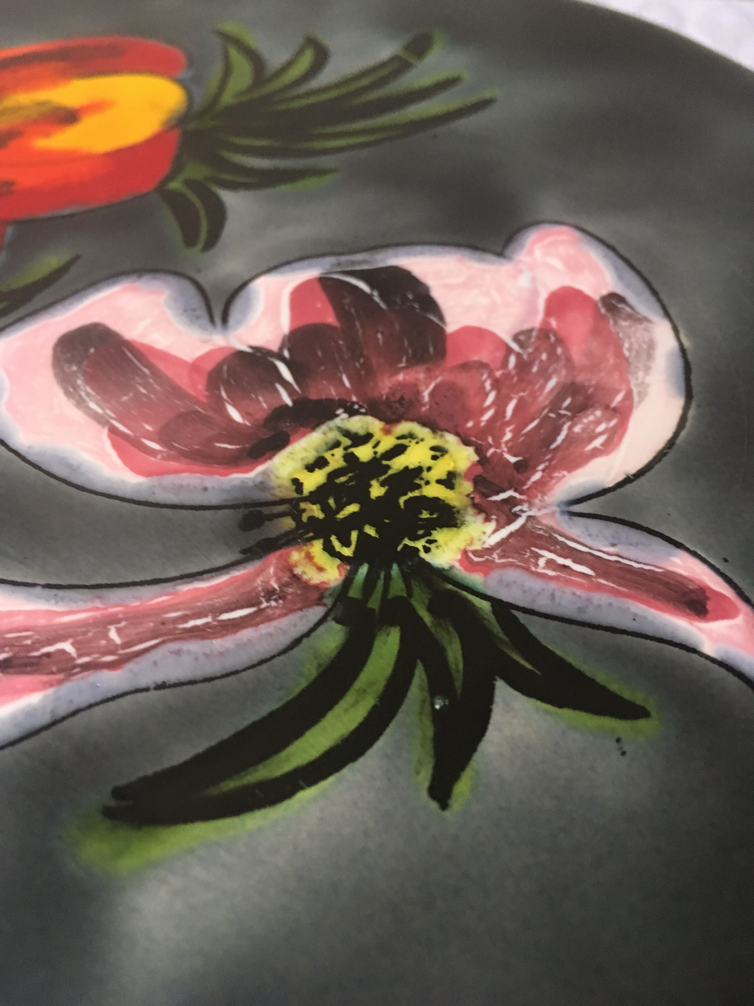 Underside of flat ceramic pink flowers La Roue de Vallauris