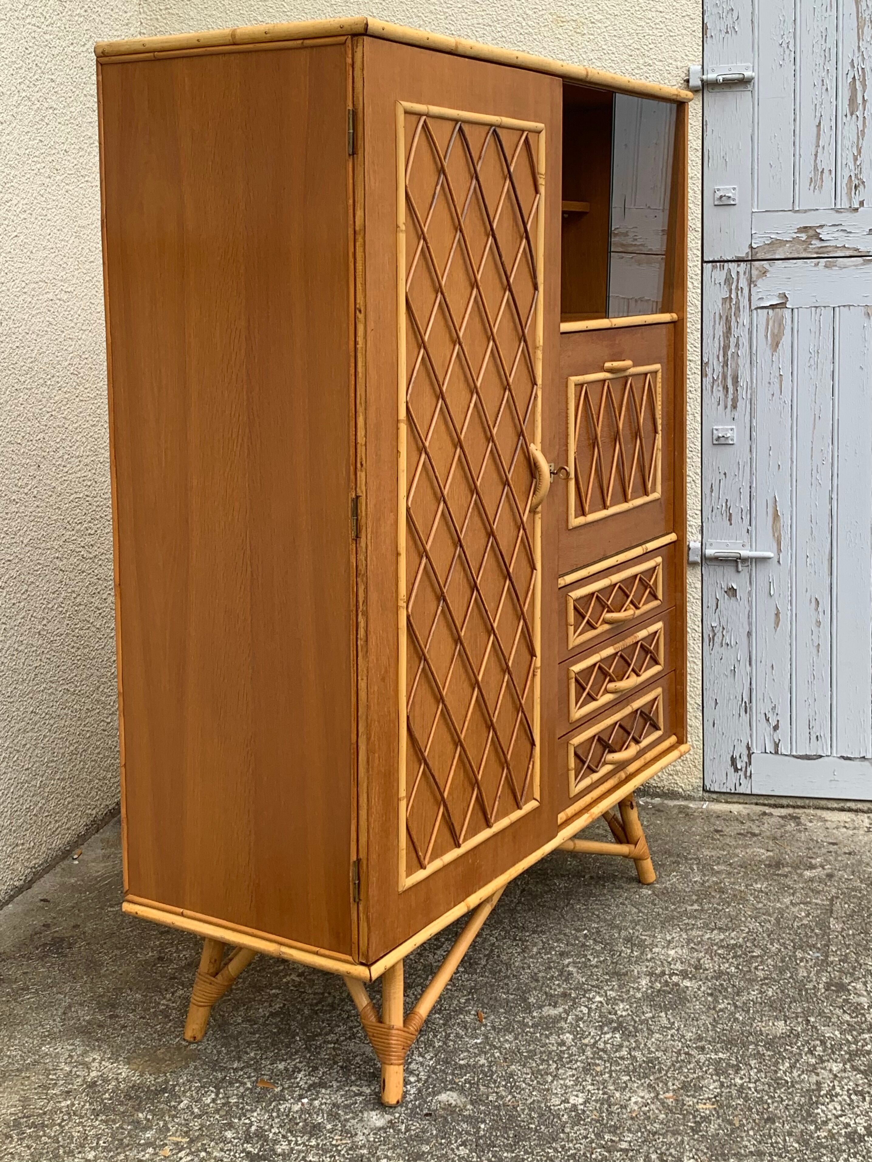 Rattan wardrobe with tapered legs from the 1960s.