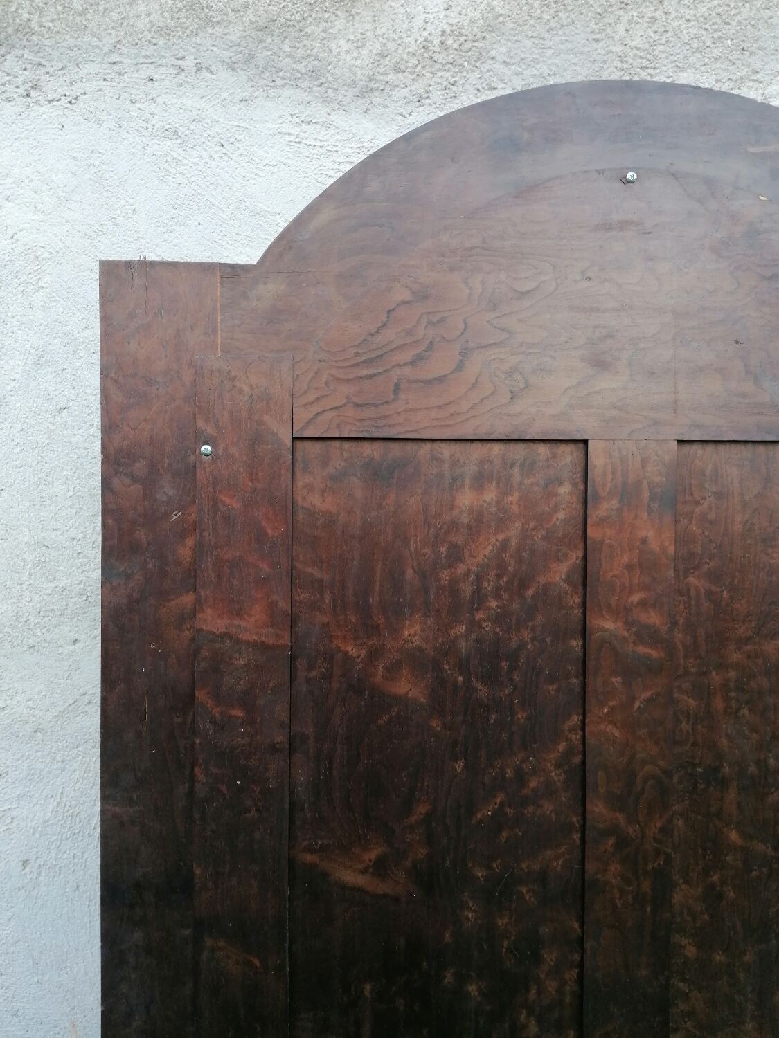 Old beveled solid wood mirror of a cabinet door.