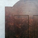 Old beveled solid wood mirror of a cabinet door.