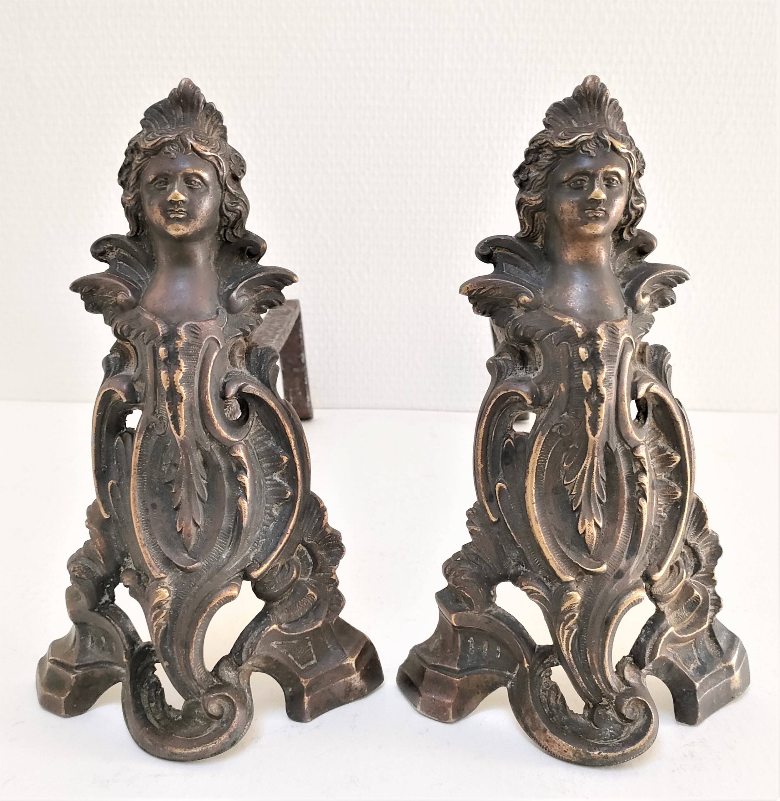 Pair of bronze andirons with black patina, 19th century, female caryatids