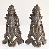 Pair of bronze andirons with black patina, 19th century, female caryatids
