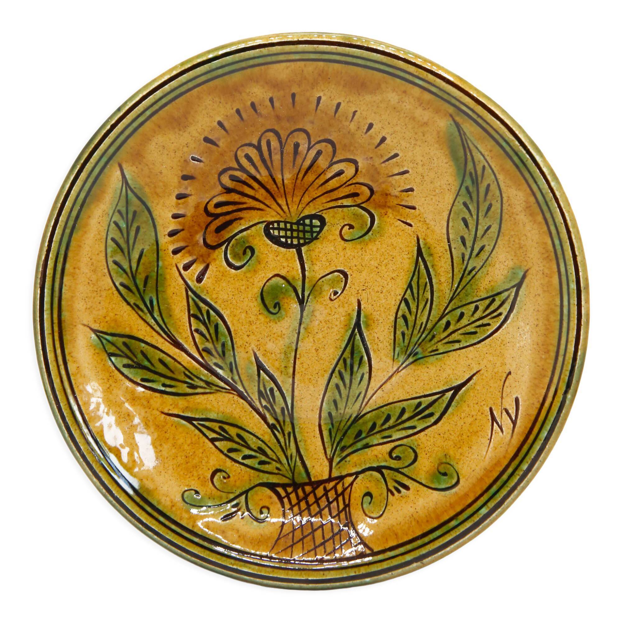 Bulgarian artisanal plate with autumn-hued flower