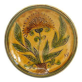 Bulgarian artisanal plate with autumn-hued flower