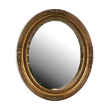 Mirror oval gilded stucco frame