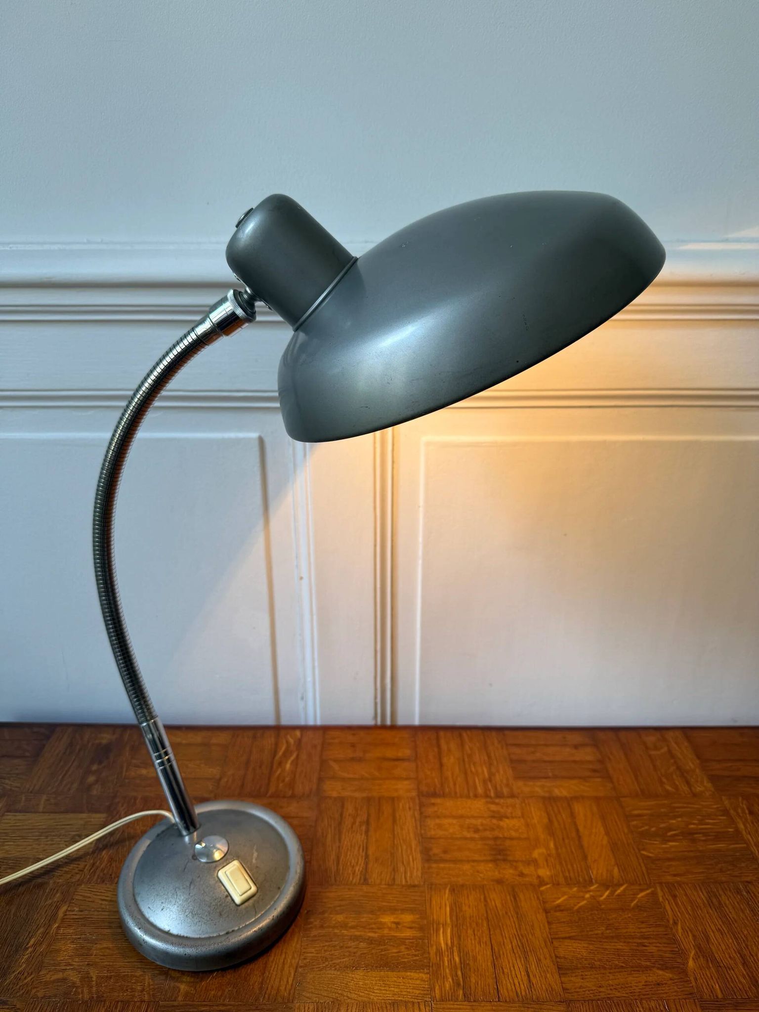 Industrial metal workshop lamp with a gooseneck.