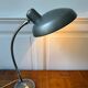 Industrial metal workshop lamp with a gooseneck.