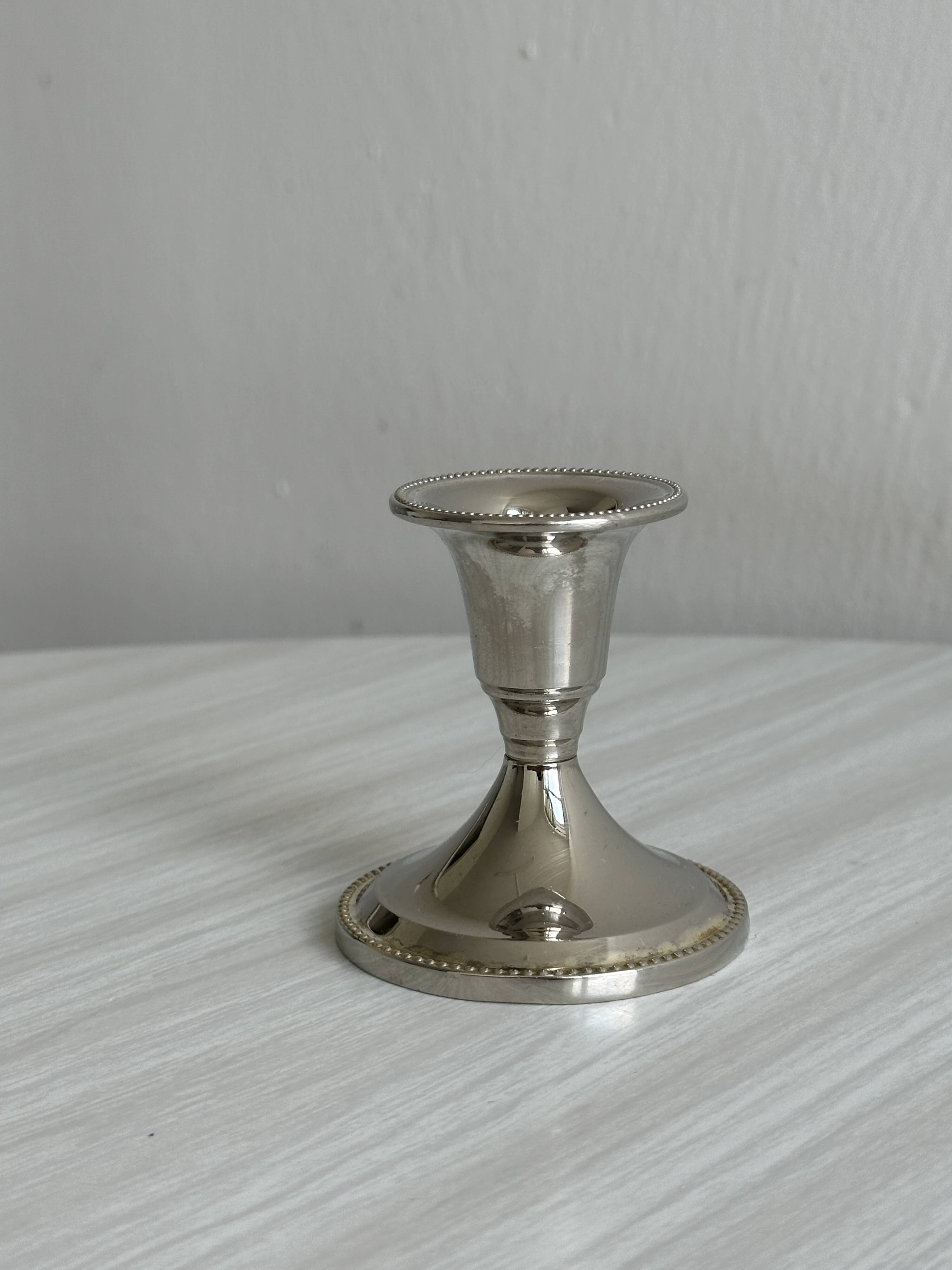 Small shiny metal candle holder