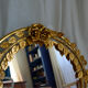 Vintage round illuminated mirror in gold metal with rose decoration.