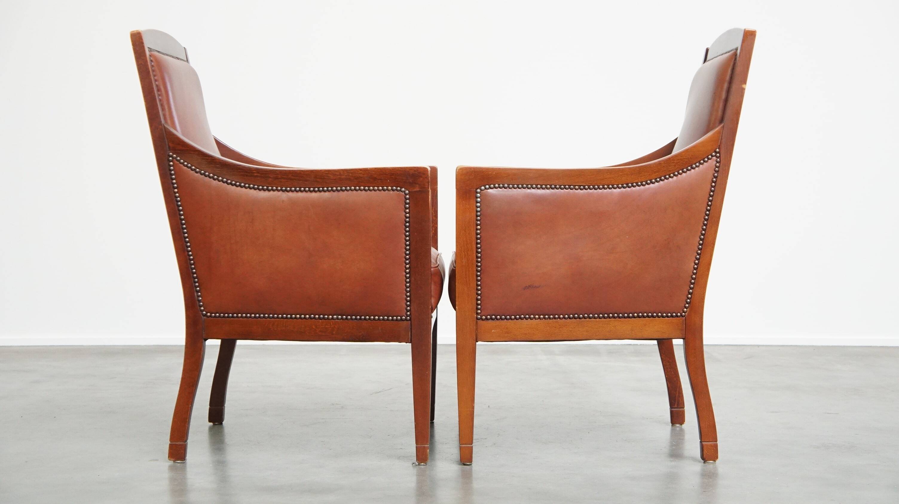 Set of 2 cognac-colored cowhide Art Deco design armchairs