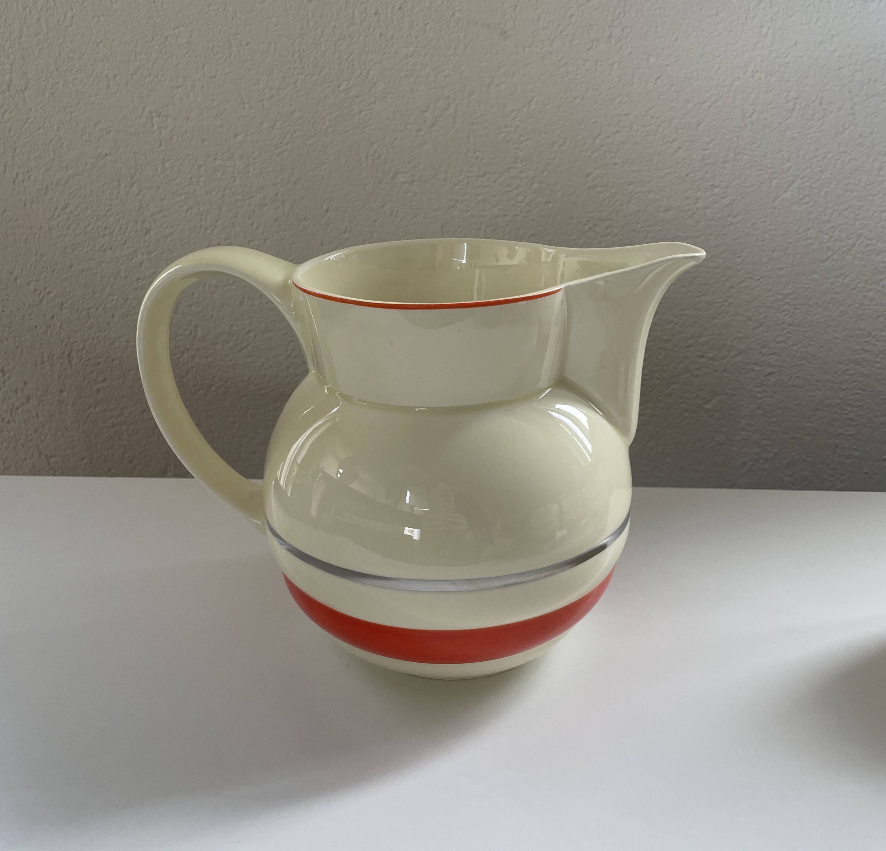 Red, white and silver porcelain jug set by Edmond Bellefroid for Robo.