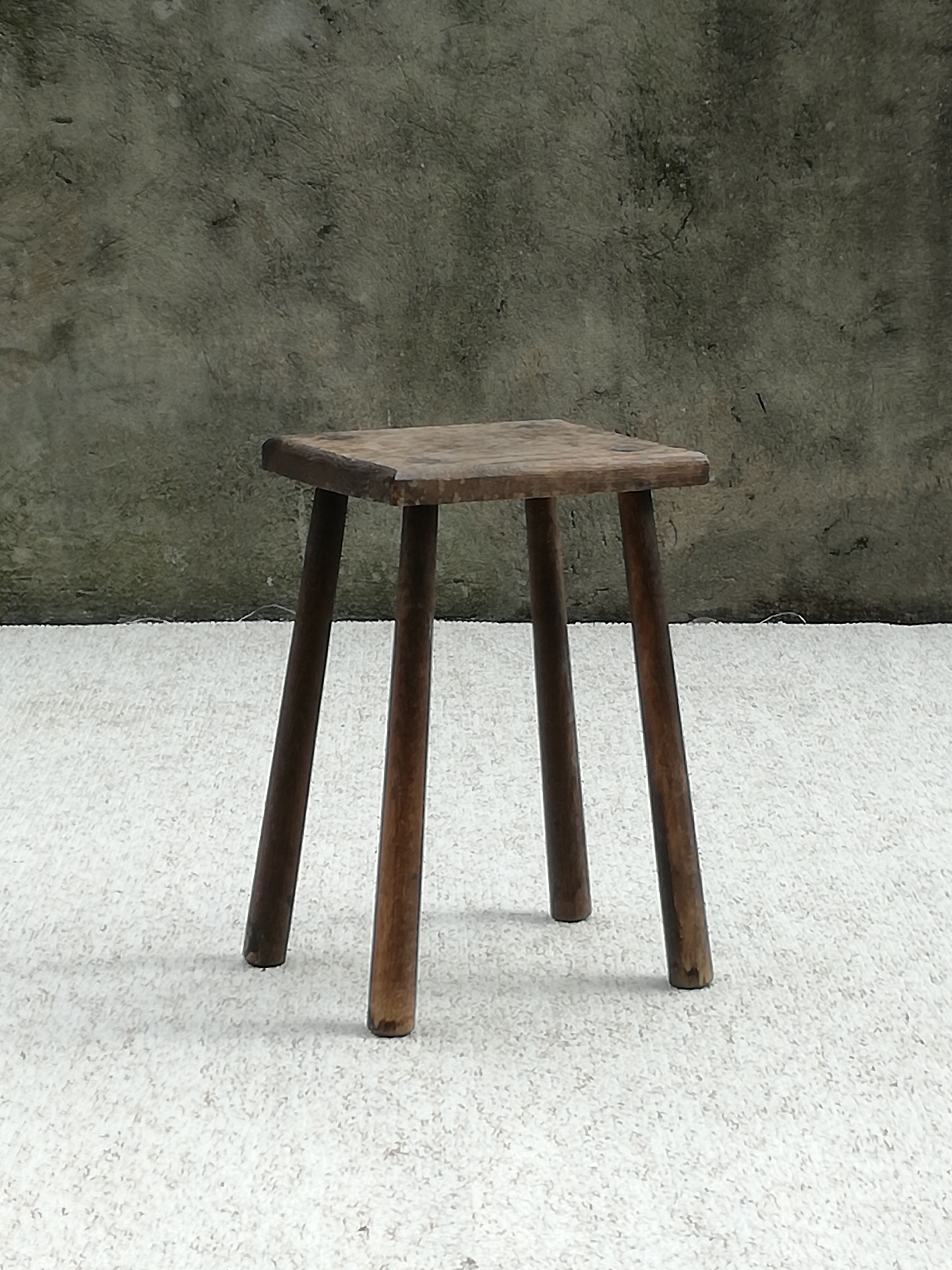 Old wooden stool with log feet
