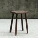 Old wooden stool with log feet