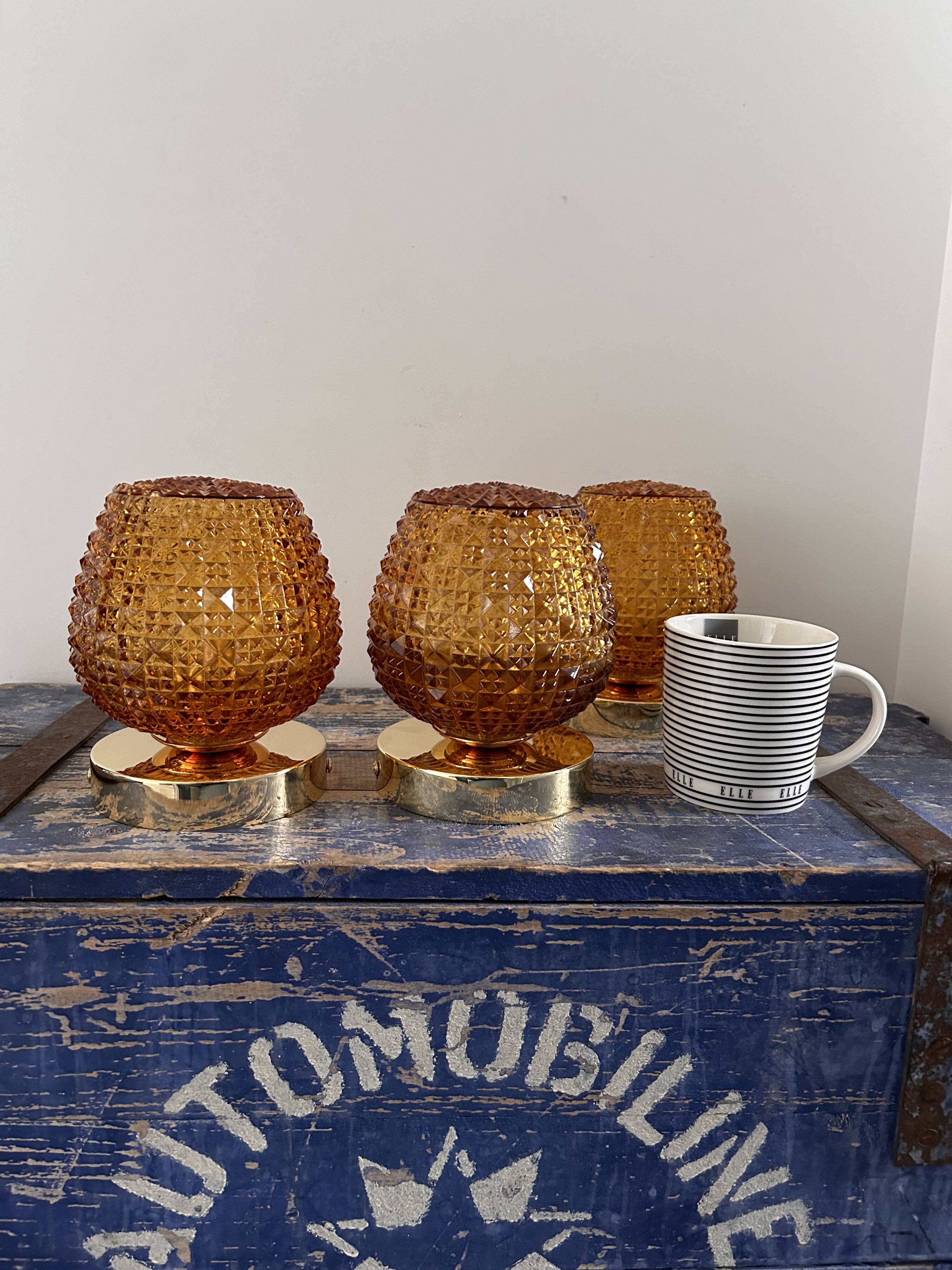 Set of three vintage wall or ceiling lights in amber chiseled glass