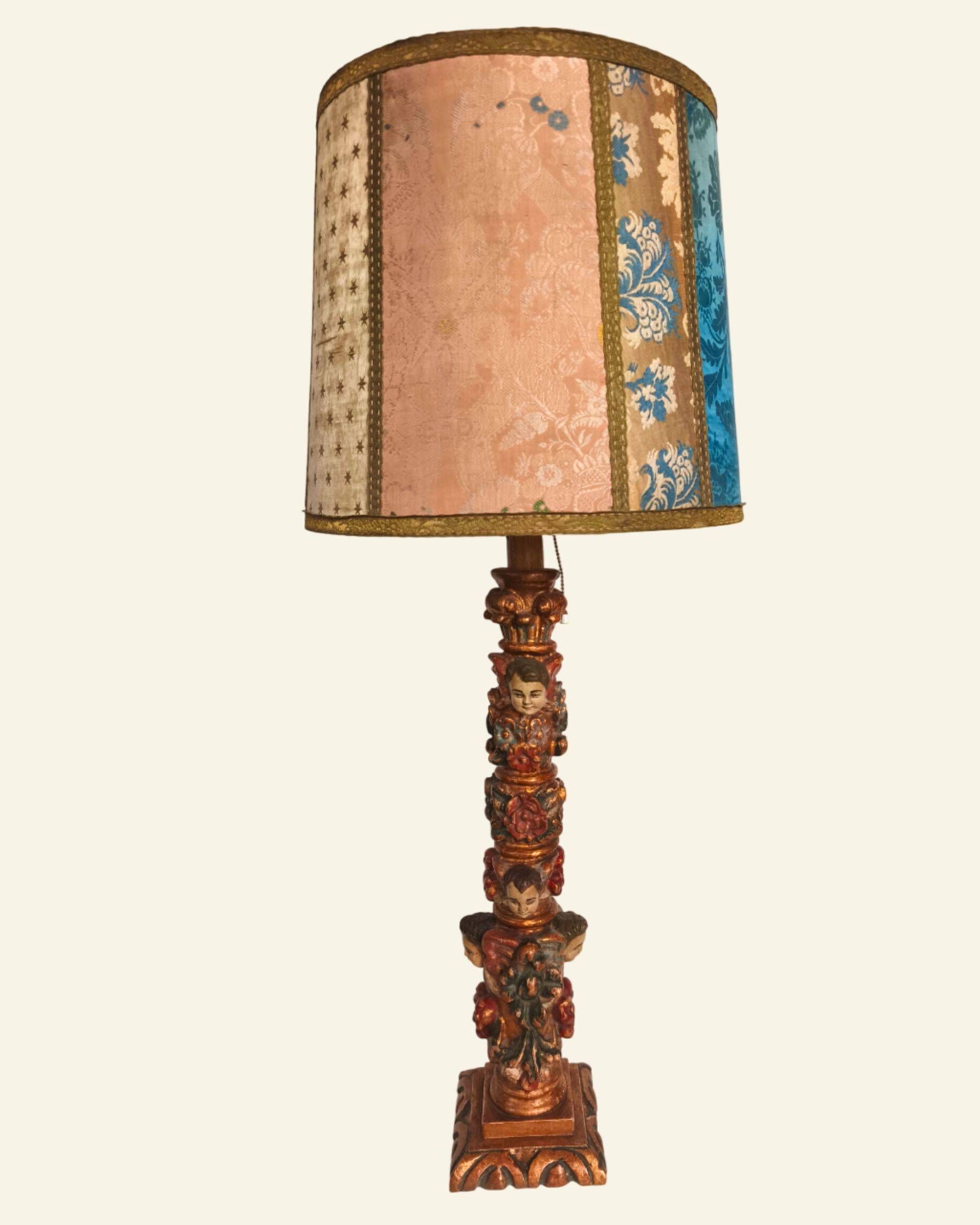 Renaissance table lamp in polychrome carved wood with cherubs.