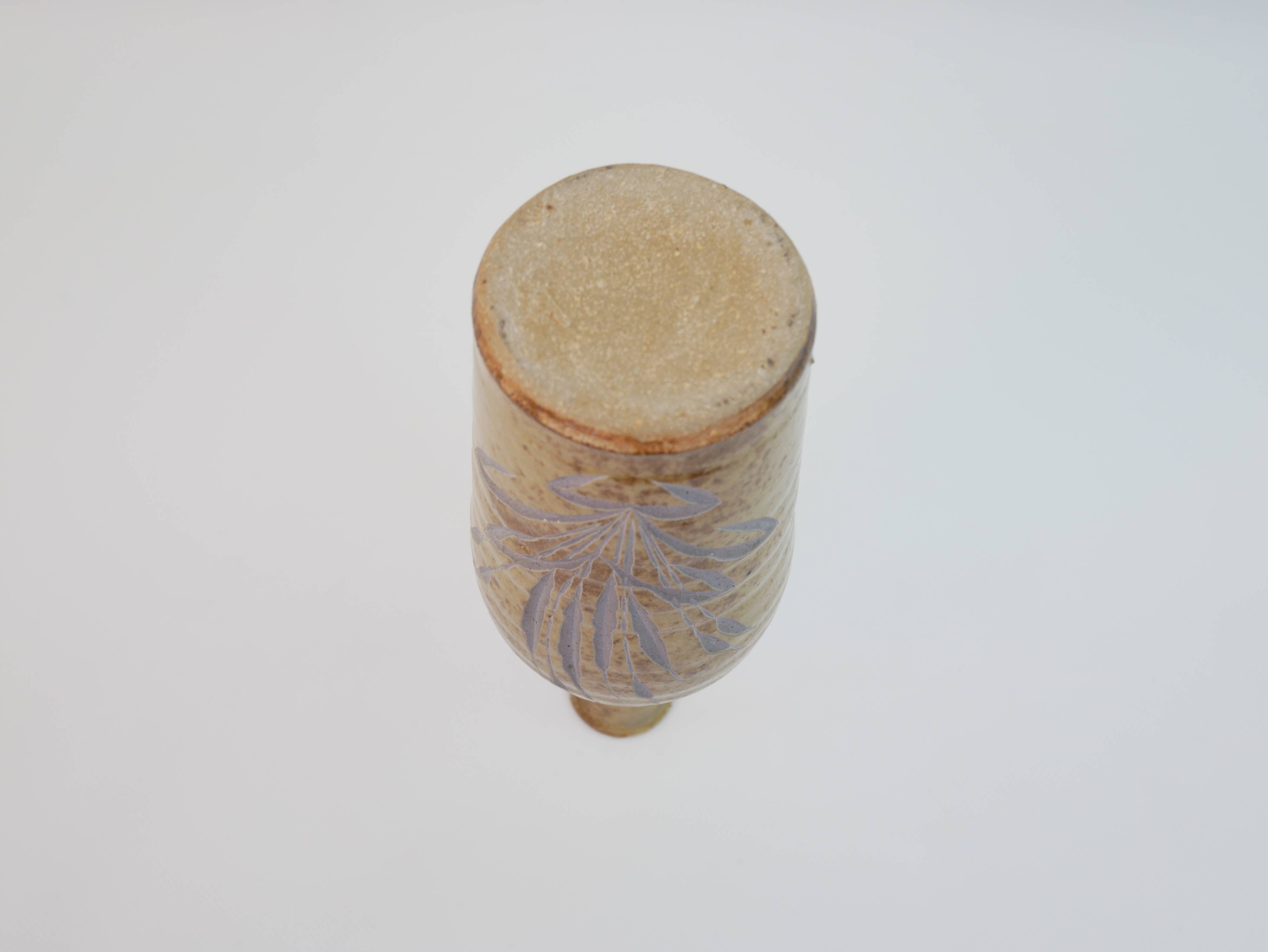 Brown ceramic/stoneware bottle with chiseled floral pattern