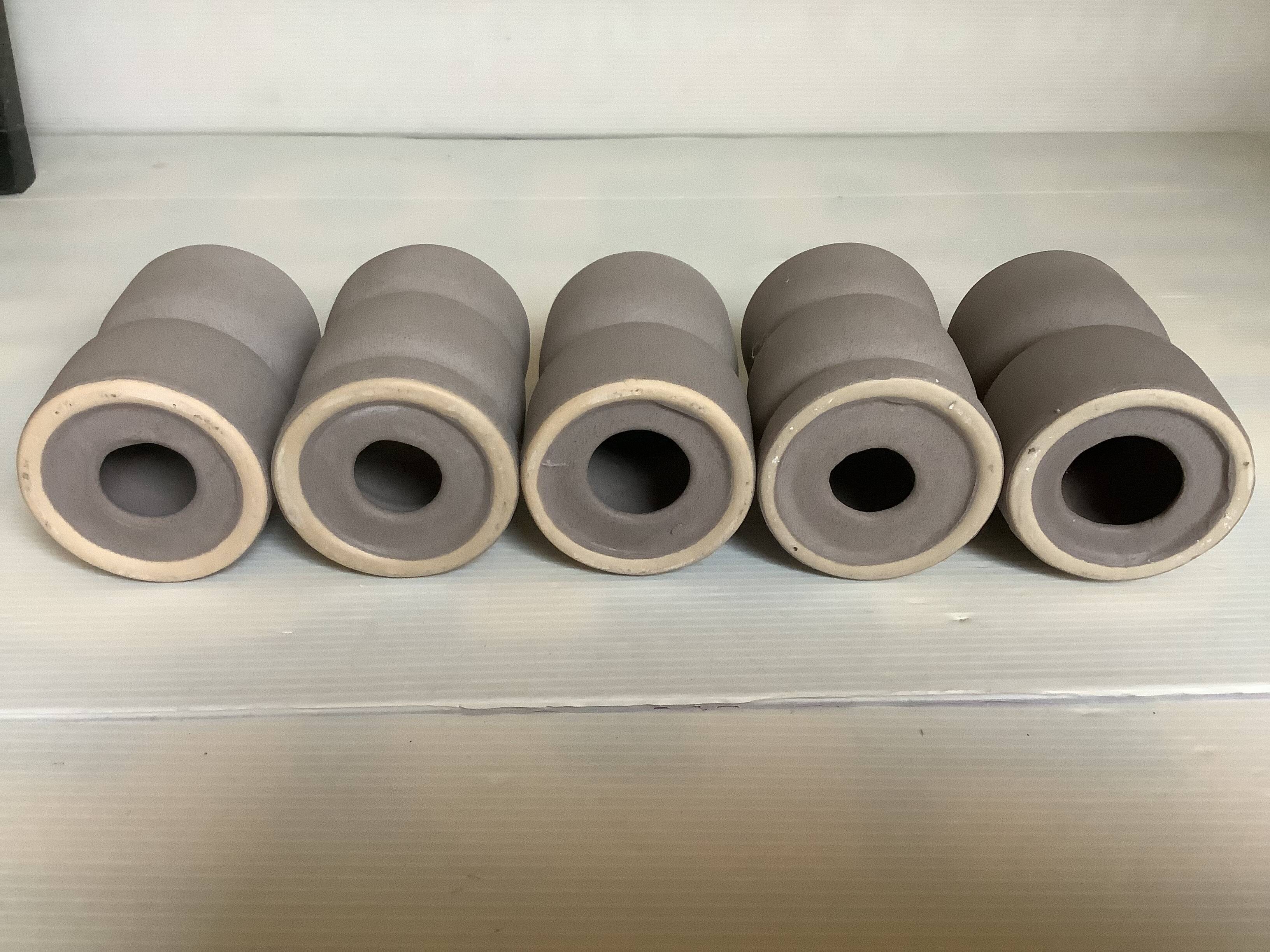 Five matte gray candle holders