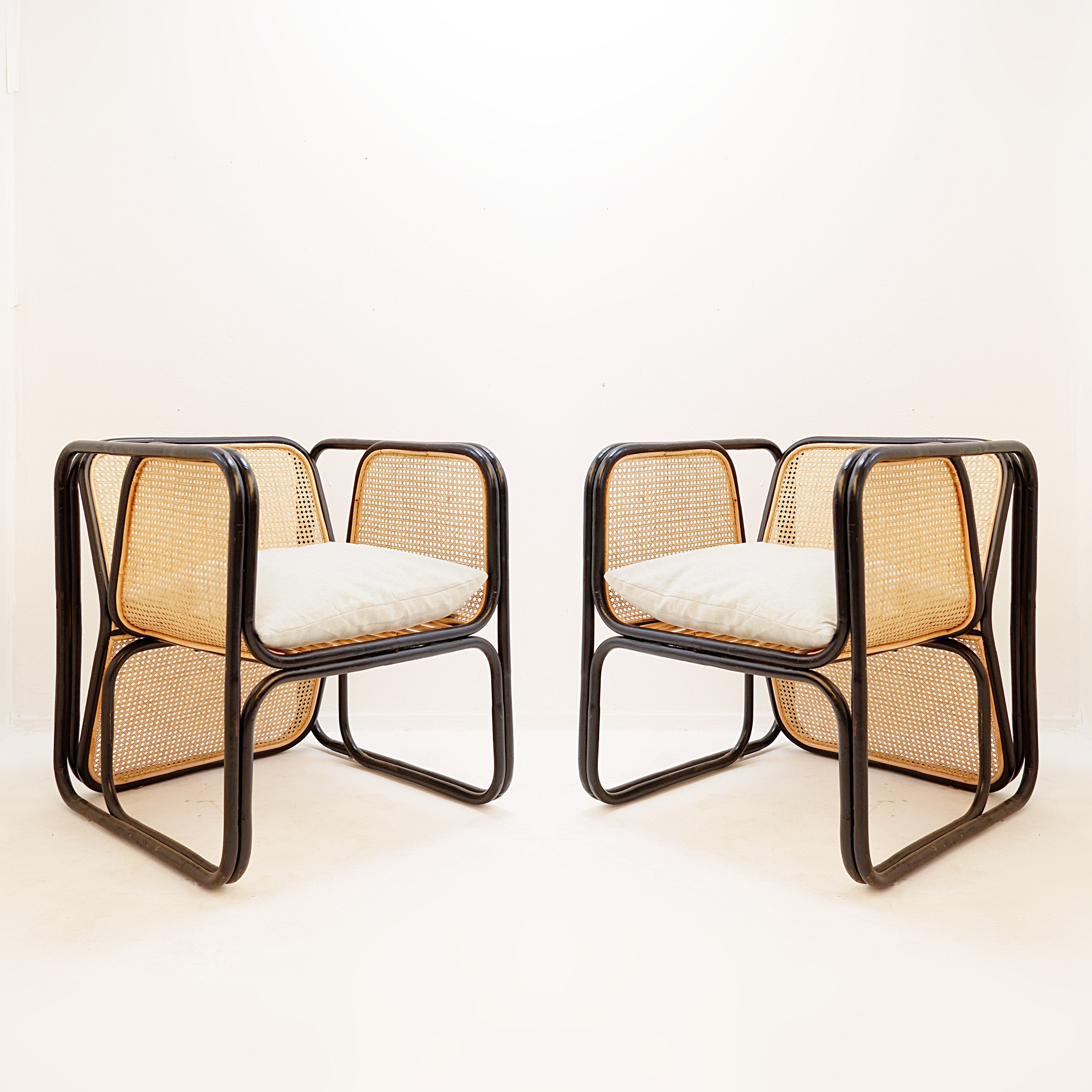 Pair of designer armchairs in curved wood and wicker