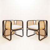 Pair of designer armchairs in curved wood and wicker