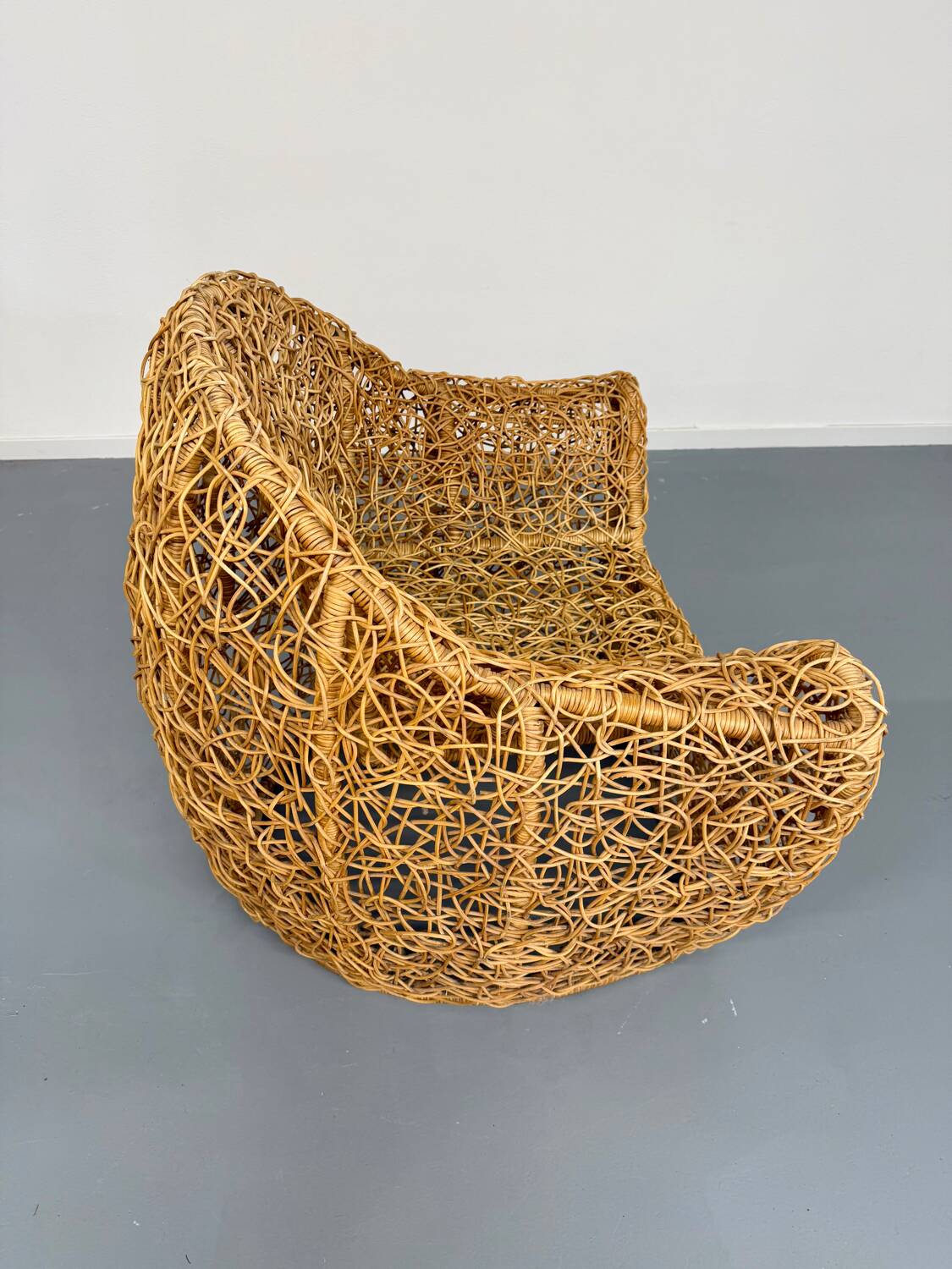 Sculptural woven rattan armchair, organic design from the 1970s.