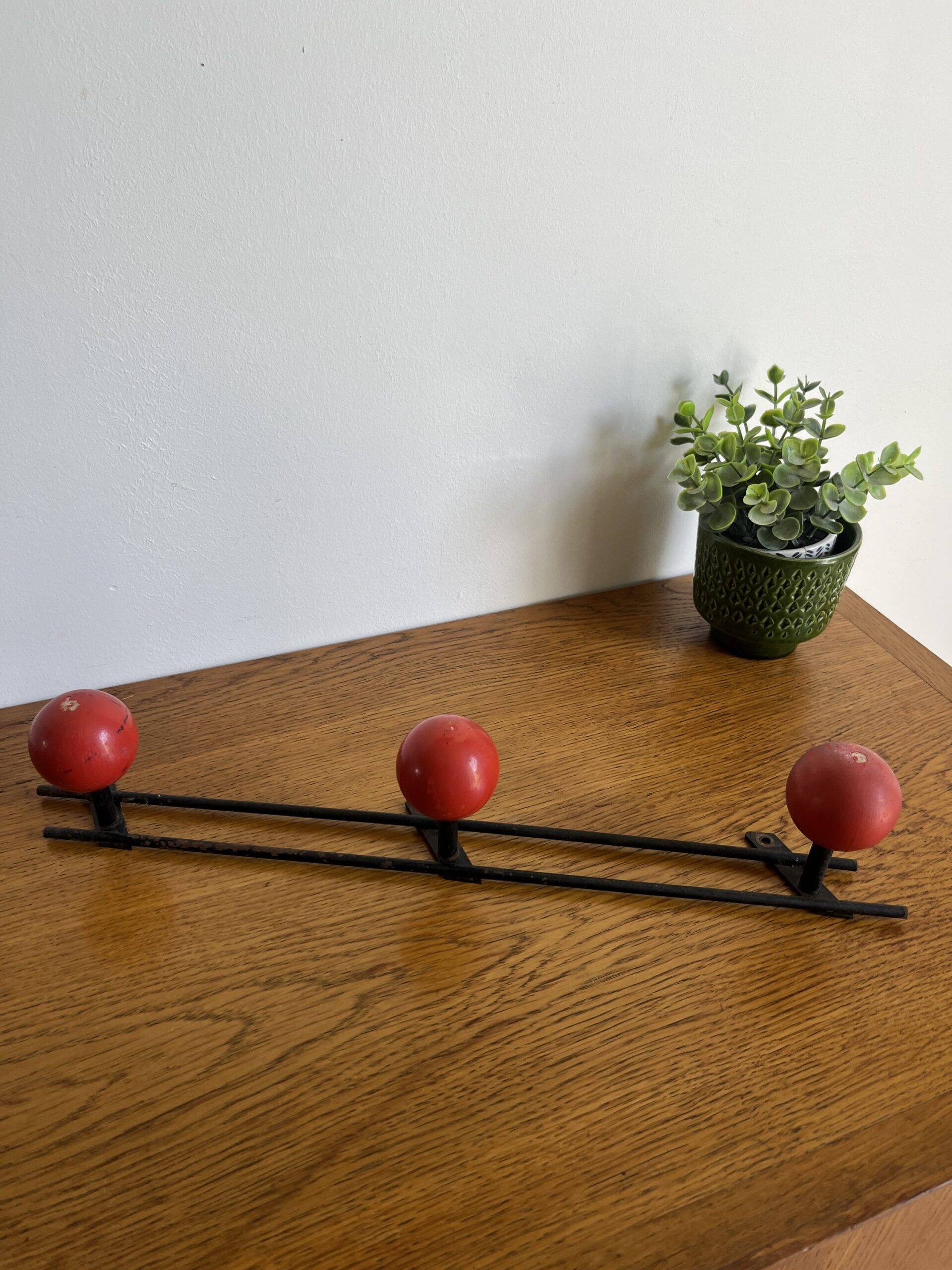 Coat rack with 3 red wooden balls