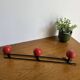 Coat rack with 3 red wooden balls
