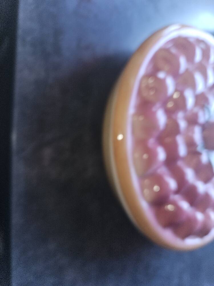 Glazed ceramic dessert plate with strawberry design.