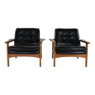 Set of two scandinavian design lounge chairs with black leather cushions