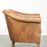 Comfortable sheepskin club armchair in a cognac colour