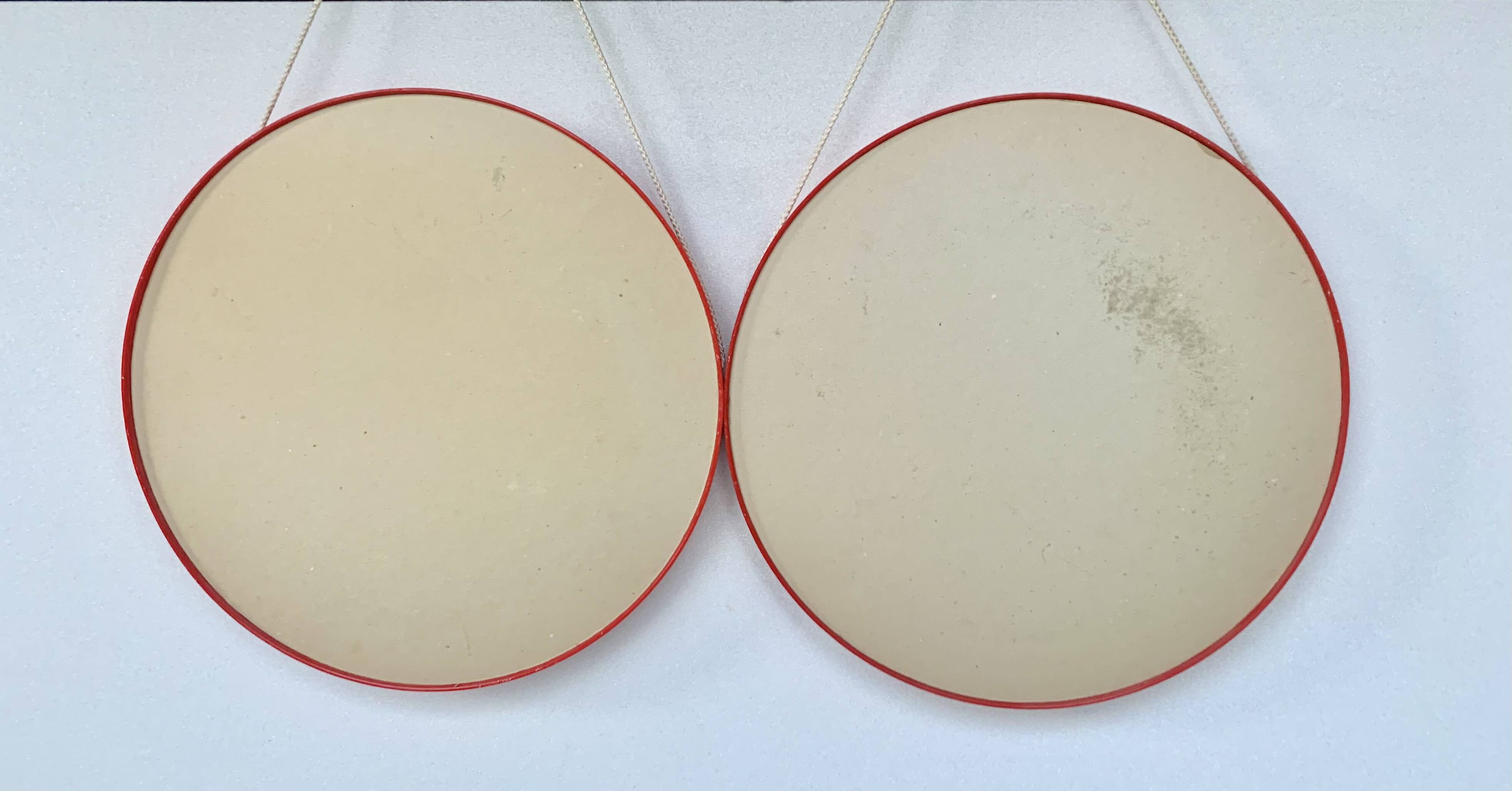 Pair of vintage round red plastic mirrors