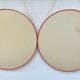 Pair of vintage round red plastic mirrors