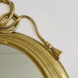 Miroir décoratif oval en laiton orné d'un important noeud torsadé