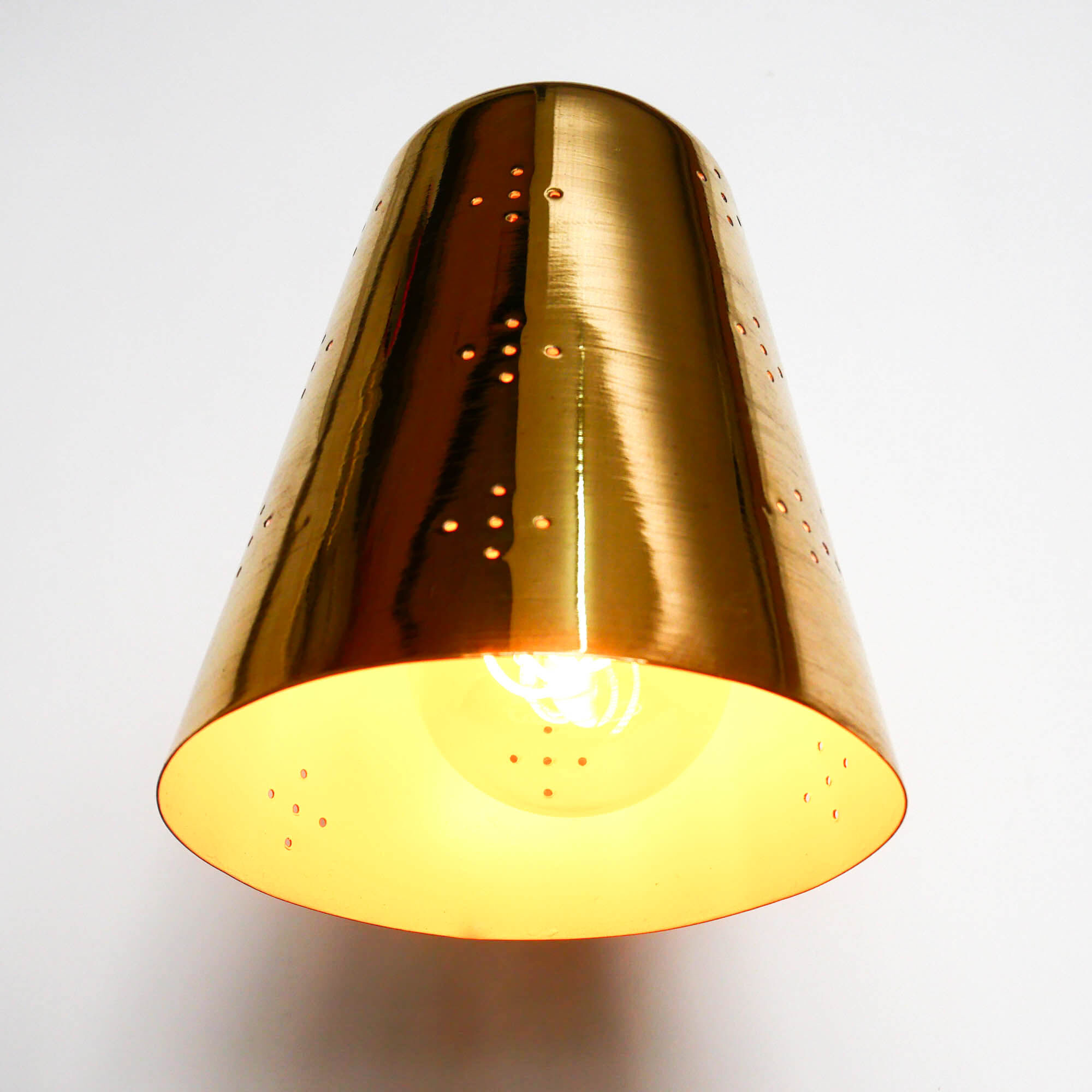 Old conical brass wall lamp, perforated lampshade