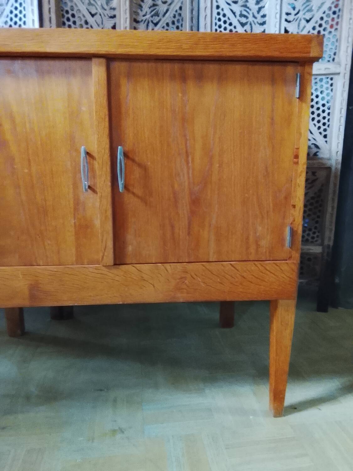 Vintage storage unit with two doors and four drawers.