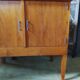 Vintage storage unit with two doors and four drawers.