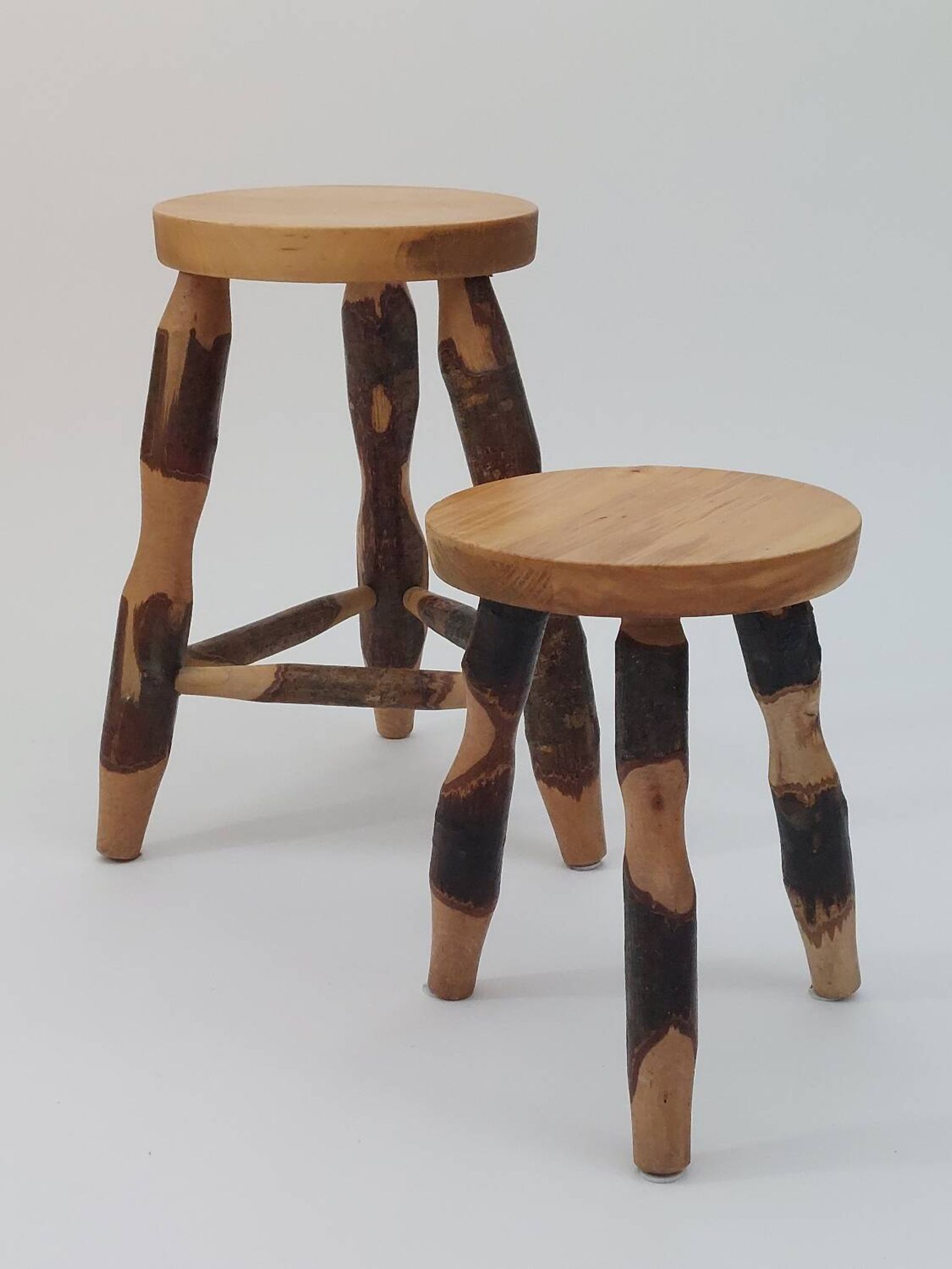 Pair of walnut stools sculpted in a vintage mid-century cross-section.