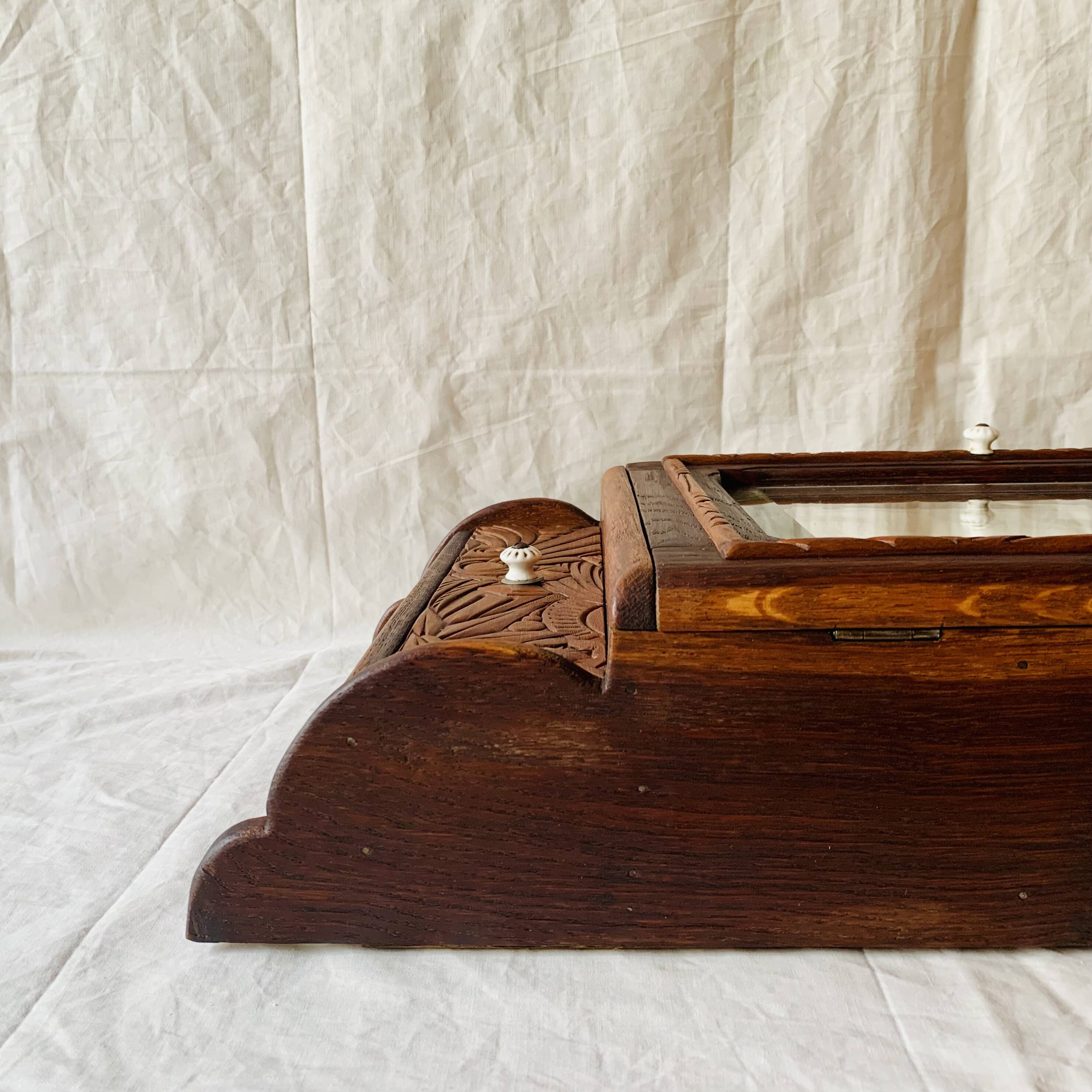 Old carved wooden medicine cabinet with beveled mirror