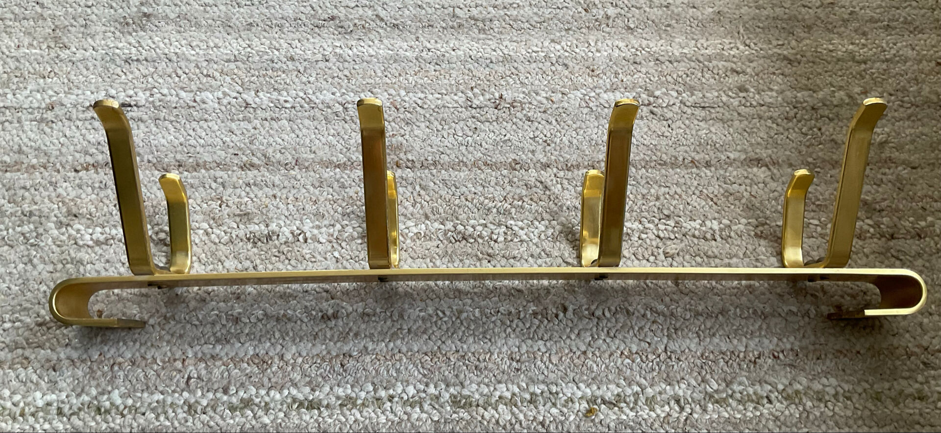 Golden wall-mounted coat rack from the 70s.