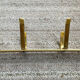 Golden wall-mounted coat rack from the 70s.