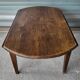 Antique round farmhouse table with drop-leaf doors in solid pegged wood