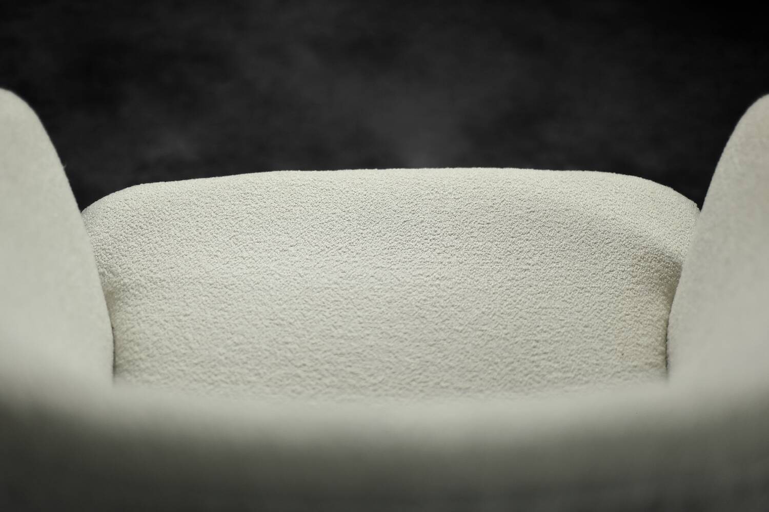 Low oak armchair with modern mid-century Scandinavian fabric and rounded backrest, 1960s.