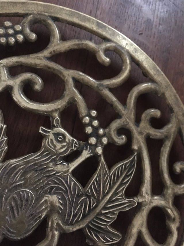 Underneath the brass dish